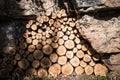 Big pile of freshly cut symmetrical tree logs stacked up high waiting to dry out in summer sunshine ready for burning symmetry Royalty Free Stock Photo