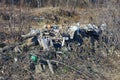 Pile of garbage in gray dry grass on nature Royalty Free Stock Photo