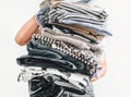 Big pile grey and beige laundry in woman hands close up image on white background Royalty Free Stock Photo