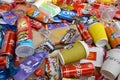 Big pile of many disposable colored trash from edible products of famous food and beverage manufacturers. Soda cans and chocolate