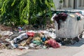 Big pile of overflow garbage and junk dumped on the street near dumpster can in the city