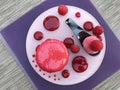 Big pink cake macaron or macaroon with raspberry and ice cream