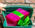 Big pink Christmas present with ribbon in a classic green mailbox Royalty Free Stock Photo