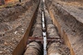 Big pipes in hole in the ground covered with dirt