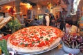 Big pizza displayed in restaurant window in Venice, Italy.