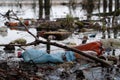 Big plastic bottles and other garbage lies on the shore of pond Royalty Free Stock Photo