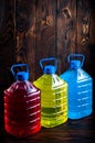 Big plastic colored bottles on a dark wood background Royalty Free Stock Photo