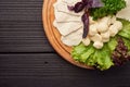 A big plate of various kinds of cheese on the wooden restaurant plate