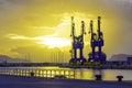 Big port cargo cranes in Palermo, Italy in a beautiful summer sunrise Royalty Free Stock Photo