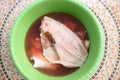 Portioned fish in green bowl