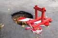 Big pothole on the road and warning sign. Road under constructon Royalty Free Stock Photo