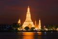 Big prang Buddhist temple Wat Arun in night lighting in the evening twilight . Bangkok
