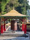 Big Prayer wheel at the entrance of the Enchey Monastry with a scenic backdrop of himalaya.