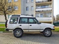 Big classic veteran dented rusty dusty British 4WD car Land Rover Discovery right side and front view