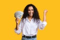 Big prize. Happy woman holding lots of money and shouting, orange background with free space Royalty Free Stock Photo