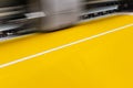 Big professional printer, processing a large scale glossy sheet of yellow paper rolls for color sampling. Royalty Free Stock Photo