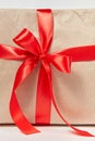 Big red bow from silk ribbon on a gift box. Close-up view. Royalty Free Stock Photo