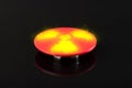 Big red button with the symbol of nuclear weapons on a black background. Glowing nuclear button in a nuclear suitcase