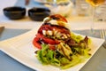 Big red french tomato served with fresh mozzarella cheese, basil pesto and creme balsamico as starter in restaurant in Provence, Royalty Free Stock Photo