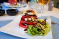 Big red french tomato served with fresh mozzarella cheese, basil pesto and creme balsamico as starter in restaurant in Provence, Royalty Free Stock Photo