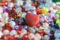 Big red heart surrounded by sequins, beads and other shiny treasure a