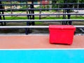 Big red ice bucket or Plastic box putting on the colorful floor Orange and Green with amphitheater or seat background Royalty Free Stock Photo