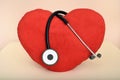 Red plush heart and stethoscope on the table Royalty Free Stock Photo