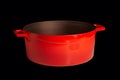 Big red pot for soup isolated on a black background Royalty Free Stock Photo