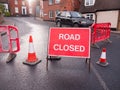 big red road closed sign fences and cones blocked path change di