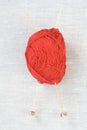 The big red skein of yarn for knitting, wooden needles Royalty Free Stock Photo