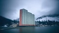 Big residential building on the seaside in a northern country. Living in harsh climate, in a remote location. Generative AI