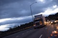 Big rig american semi truck tractor on highway in twilight Royalty Free Stock Photo