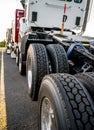 Big rig semi truck transports new semi trucks tractor loaded on top of one another Royalty Free Stock Photo