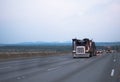 Big rig car hauler semi truck running in front of another traffic Royalty Free Stock Photo