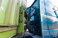 Big rig classic green semi truck with capacity compartment behind of tractor cab transporting bulk semi trailer Royalty Free Stock Photo