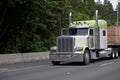 Big rig classic semi truck with flat bed trailer trancport lumber wood Royalty Free Stock Photo