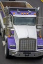 Big rig tip truck with empty dump trailer running on the road to point of work for load