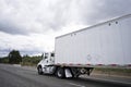 Big rig day cab local delivery semi truck transporting semi trailer on the road Royalty Free Stock Photo