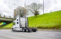 Big rig diesel semi truck tractor running on the highway road to warehouse for pick up loaded semi trailer Royalty Free Stock Photo