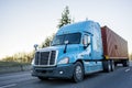 Big rig long haul semi truck transporting container on the highway Royalty Free Stock Photo