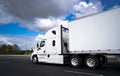 Big rig long haul semi truck transporting goods in semi trailer Royalty Free Stock Photo