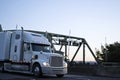 Big rig powerful semi truck running on evening twilight road Royalty Free Stock Photo