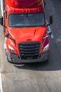 Big rig red semi truck tractor with semi trailer driving on the wide road Royalty Free Stock Photo