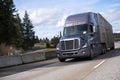 Big rig semi truck running highway with trailer for animals