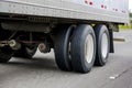 Big rig semi truck transporting cargo in dry van semi trailer with two axles running on the wide highway road