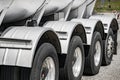 Big rig semi truck transporting heavy loaded tank semi trailer with four axles and wheels with endurance tires running on the Royalty Free Stock Photo