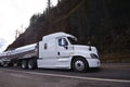 Big rig semi truck transporting liquid cargo in stainless steel