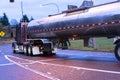 Big rig semi truck transporting liquid in tank semi trailer turn Royalty Free Stock Photo