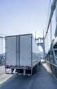 Big rig semi truck transporting semi trailer driving on the arch bridge Royalty Free Stock Photo