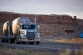 Big rig semi truck with two bulk semi trailer running on the win Royalty Free Stock Photo